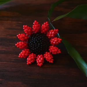 Red and black brooch discount