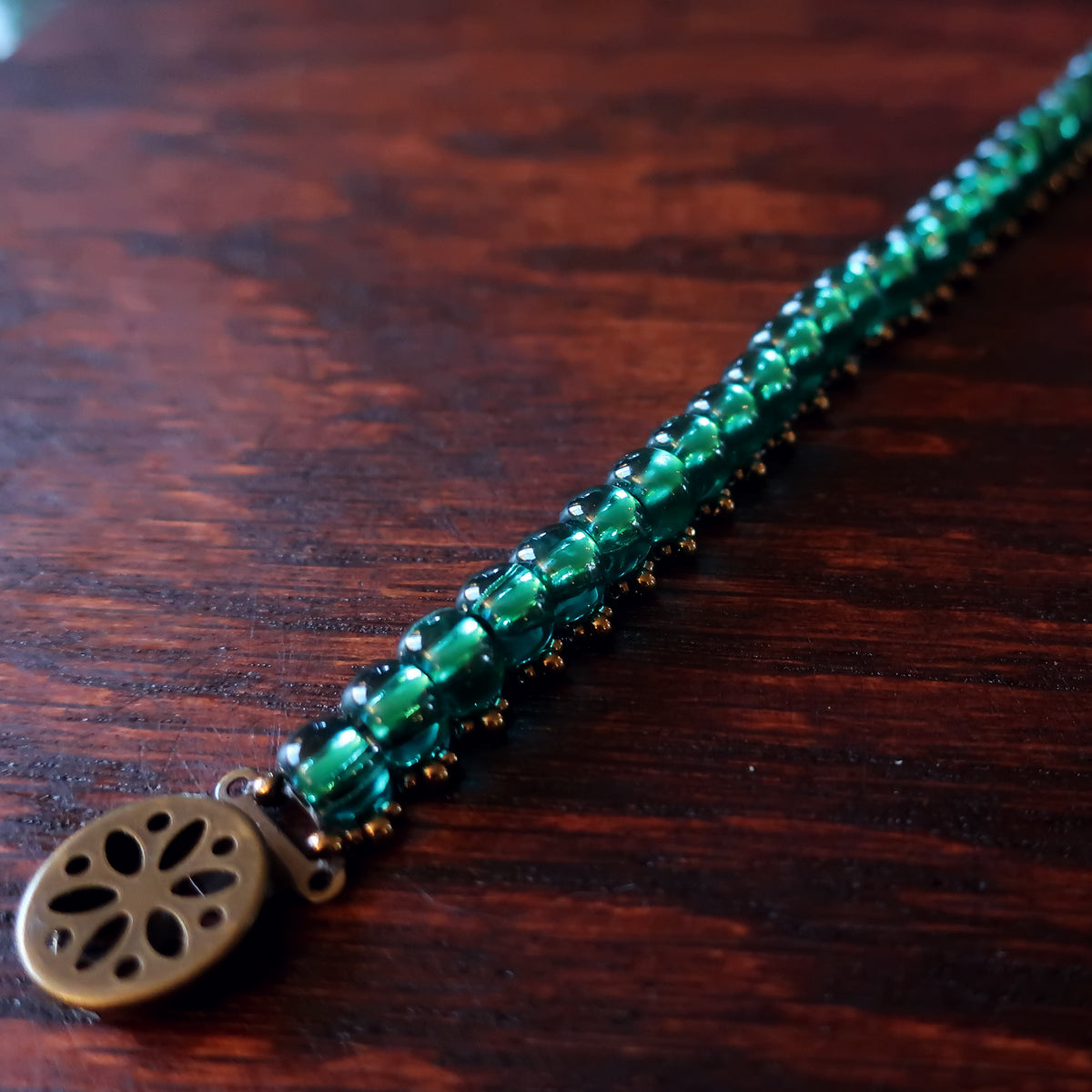 Temple Tree Boho Glass Bead Caterpillar Weave Bracelet -Sparkly Emerald and Bronze